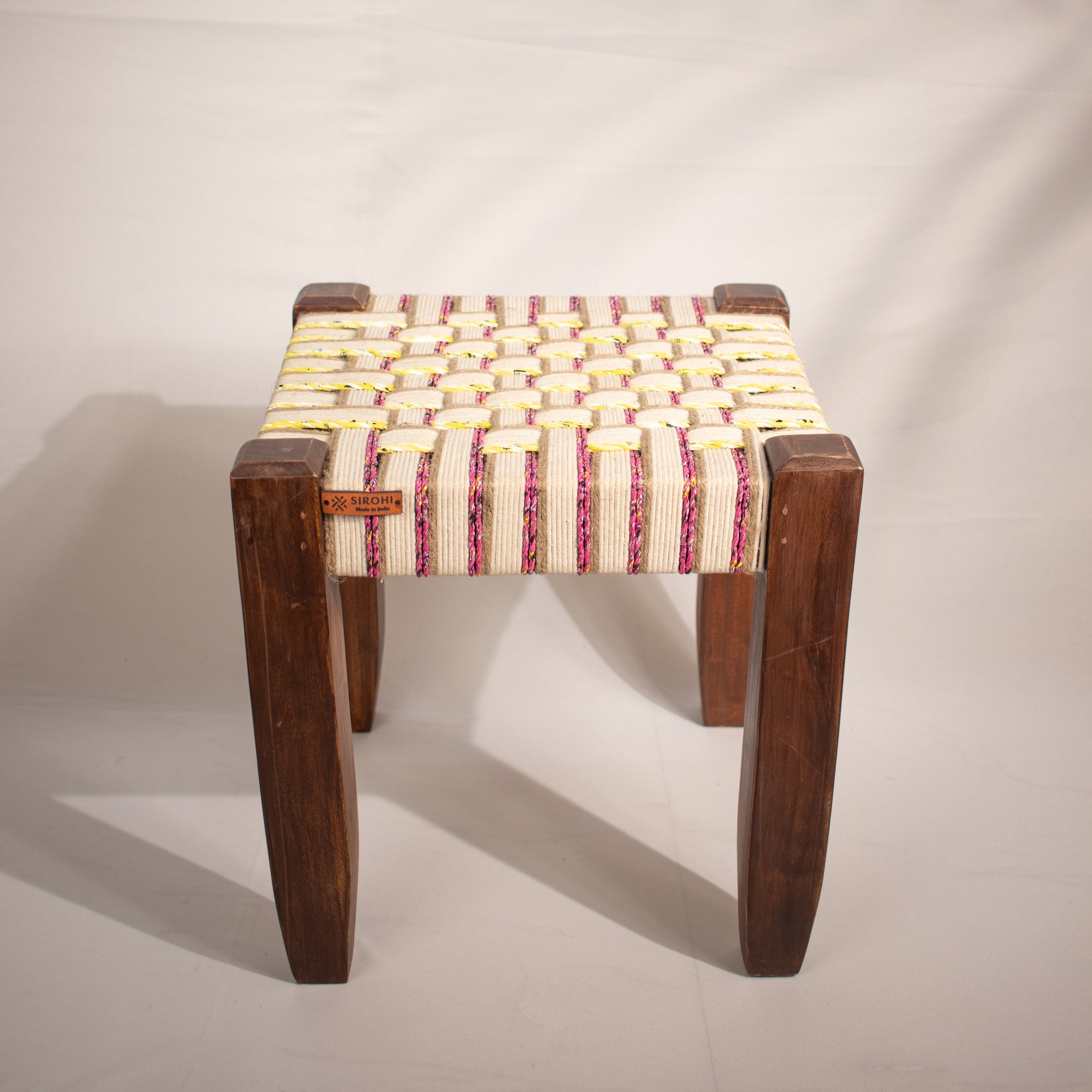 White, yellow and pink wooden stool
